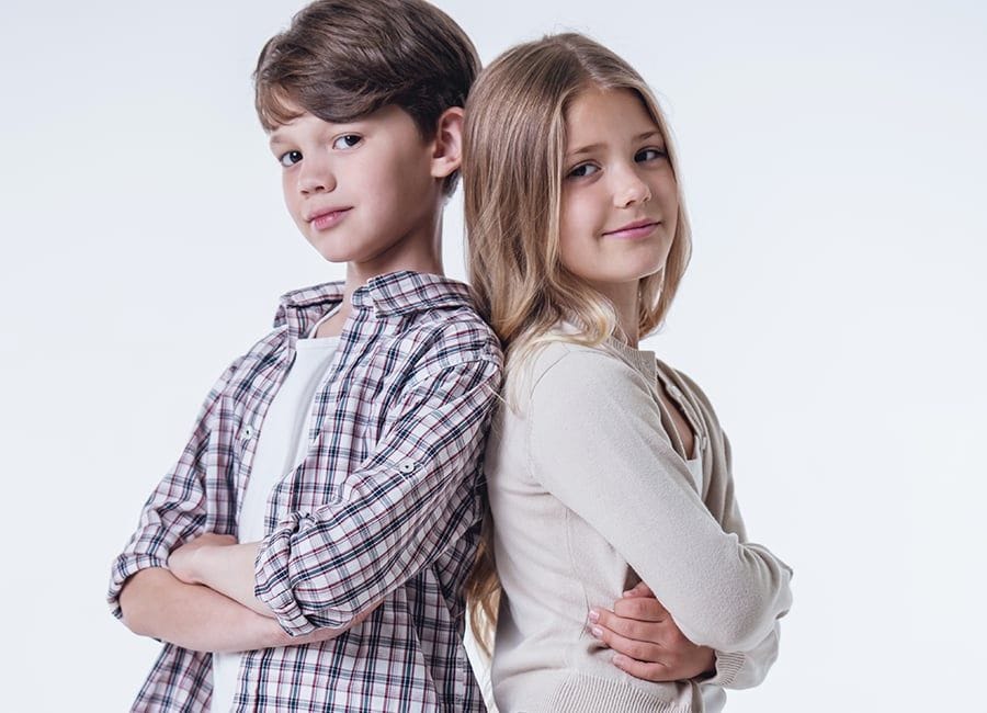 Boy and girl back to back